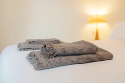 two towels sitting on top of a bed at RESORT BEACH VALENCIA in Valencia