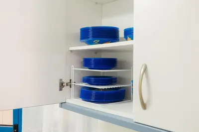a pantry with blue plates and bowls on shelves at RESORT BEACH VALENCIA in Valencia