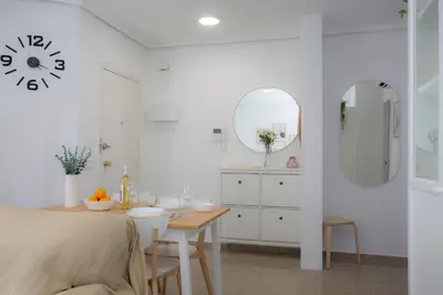 a white bathroom with a table and a sink at SingularStays Campanar in Valencia