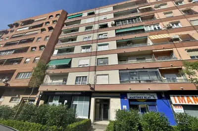 an apartment building with a blue door in front of it at SingularStays Campanar in Valencia