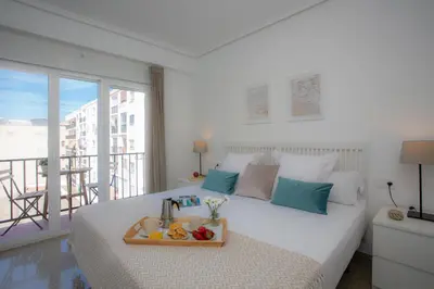 a bedroom with a bed with a tray of fruit on it at SingularStays Campanar in Valencia