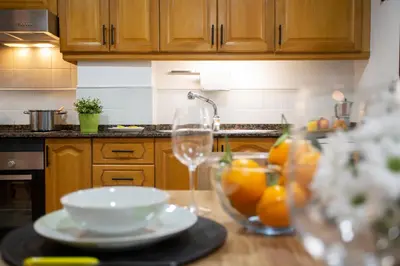 a kitchen with a table with a bowl of oranges at SingularStays Clero in Valencia
