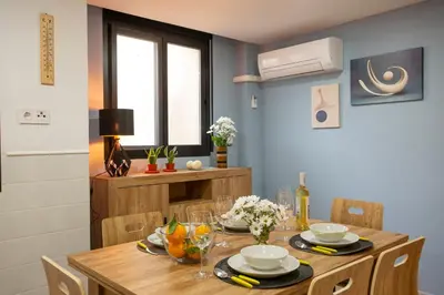 a dining room with a wooden table and chairs at SingularStays Clero in Valencia