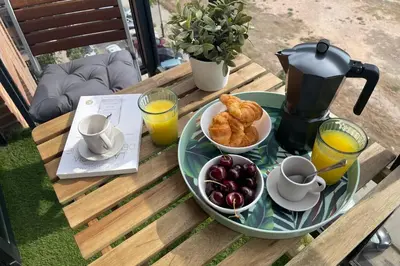 a table with a breakfast of croissants and orange juice at SingularStays Oceanografico II in Valencia