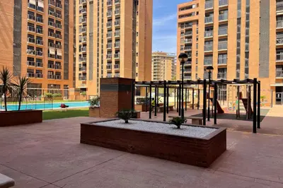 a playground in a city with tall buildings at SingularStays Oceanografico II in Valencia