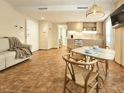 a kitchen and a living room with a table and chairs at Apartamentos Las Ciencias Studio Z in Valencia