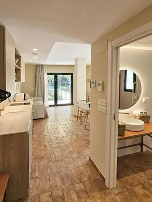 a kitchen and living room with a table and a couch at Apartamentos Las Ciencias Studio X in Valencia