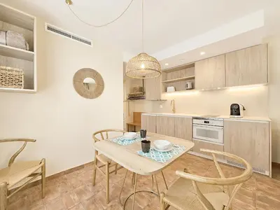 a kitchen with a table and chairs in a room at Apartamentos Las Ciencias Studio X in Valencia