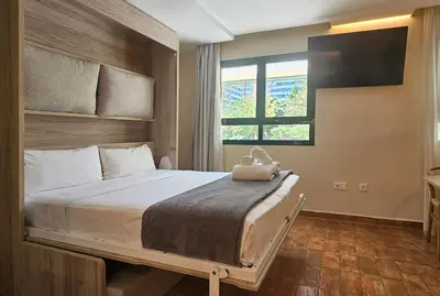a bedroom with a large bed with a window at Apartamentos Las Ciencias Studio T in Valencia