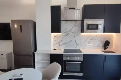 a kitchen with black and white marble counter tops at Estudio diseño cerca Ciudad Ciencias VT-55211-V in Valencia