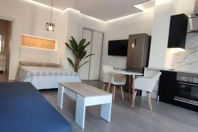 a bedroom with a bed and a desk in a room at Estudio diseño cerca Ciudad Ciencias VT-55211-V in Valencia