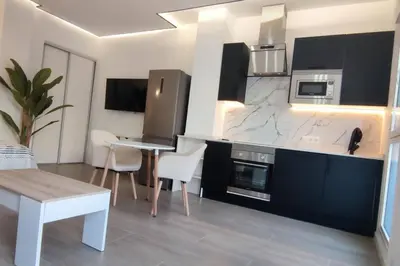 a kitchen with a table and chairs in a room at Estudio diseño cerca Ciudad Ciencias VT-55211-V in Valencia