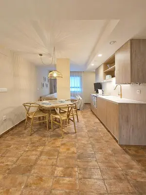 a kitchen and dining room with a table and chairs at Apartamentos Las Ciencias U in Valencia