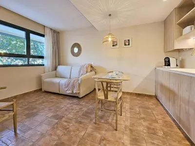 a living room with a table and a couch at Apartamentos Las Ciencias V in Valencia
