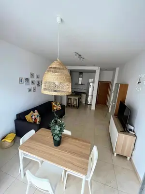 a living room with a table and a couch at Valencia Beach Apartment - La Patacona in Valencia