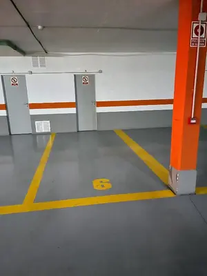 an empty parking garage with a yellow line on the floor at Valencia Beach Apartment - La Patacona in Valencia
