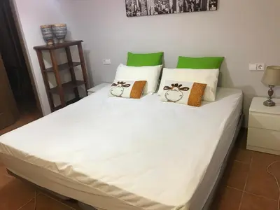 a large white bed with pillows on top of it at Alto Oasis in Siete Aguas