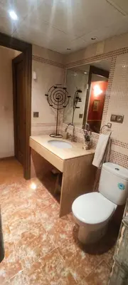 a bathroom with a toilet and a sink and a mirror at Alto Oasis in Siete Aguas