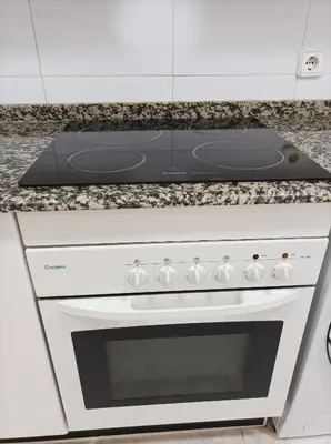 a white stove top oven in a kitchen at Almar Collection Cullera Bahía Park in Cullera
