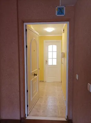 a hallway with a white door and a window at Almar Collection Cullera Bahía Park in Cullera