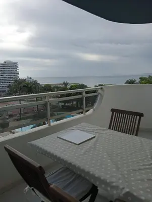 a table and chairs on a balcony with the ocean at LAS VEGAS, esc-1, 7-14 in Cullera