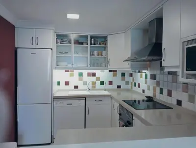 a kitchen with white cabinets and a white refrigerator at LAS VEGAS, esc-1, 7-14 in Cullera