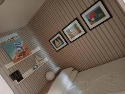a room with a bed with pictures on the wall at LAS VEGAS, esc-1, 7-14 in Cullera