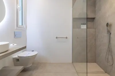 a bathroom with a toilet and a glass shower at Ca Celieta Beach I in Valencia