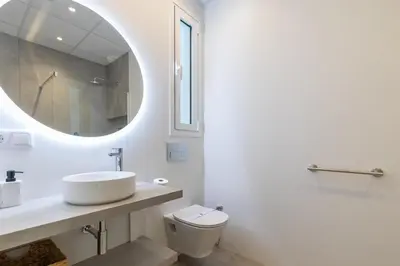 a white bathroom with a sink and a mirror at Ca Celieta Beach I in Valencia