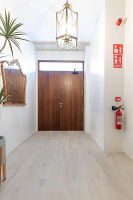 a hallway with a wooden door in a room at Ca Celieta Beach I in Valencia