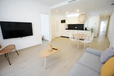 a living room with a blue couch and a table at Ca Celieta Beach II in Valencia