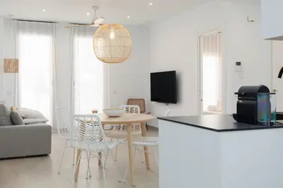 a kitchen and living room with a table and chairs at Ca Celieta Beach II in Valencia