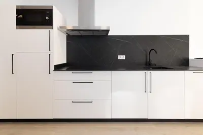 a kitchen with white cabinets and a sink at Ca Celieta Beach III in Valencia