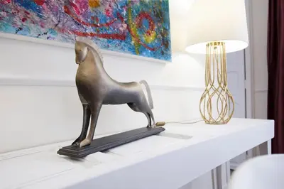 a statue of a horse on a shelf next to a lamp at Family Century House with terrace and parking in Valencia