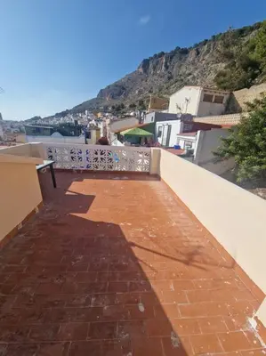 a brick walkway on a building with a view of a mountain at Casa Pagan in Cullera