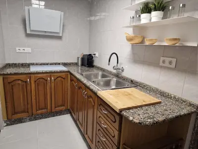 a kitchen with a sink and a counter at Casa Pagan in Cullera