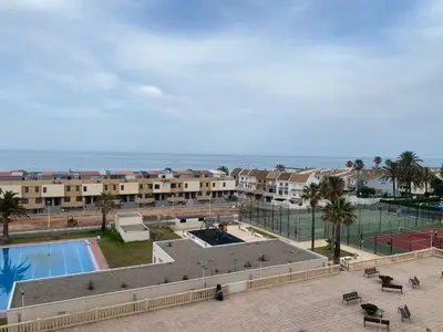 an aerial view of a resort with a swimming pool and the ocean at Travel Habitat Playa del Puig in Valencia