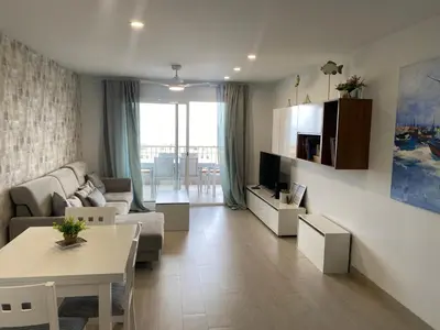 a living room with a couch and a table at Travel Habitat Playa del Puig in Valencia