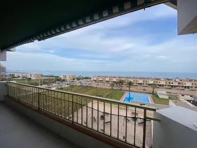 a balcony with a view of a swimming pool at Travel Habitat Playa del Puig in Valencia