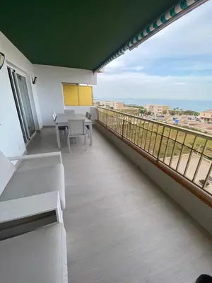 a balcony with a table and a view of the ocean at Travel Habitat Playa del Puig in Valencia