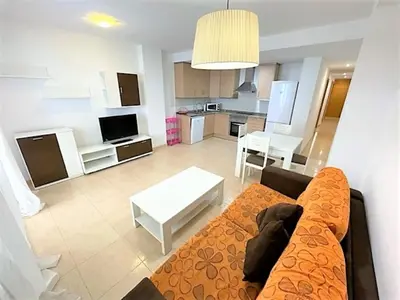 a living room with a couch and a kitchen at Apartment Grao de Moncofar Ref 041 in Moncófar