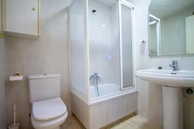 a bathroom with a toilet and a sink and a shower at ESPACIO 3 - Primera Línea de Playa in Cullera