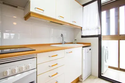 a kitchen with white cabinets and a sink at ESPACIO 3 - Primera Línea de Playa in Cullera