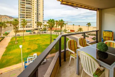a balcony with a table and chairs and a view of the beach at ESPACIO 3 - Primera Línea de Playa in Cullera