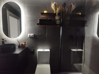 a bathroom with a toilet and a sink and a mirror at Portrait Boutique Apartment in Valencia