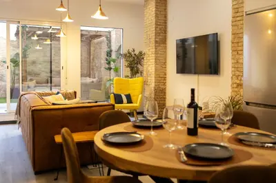 a living room with two tables and a couch at Portrait Boutique Apartment in Valencia