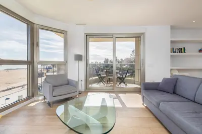 a living room with a couch and a glass table at ApartUP Patacona Deluxe in Valencia