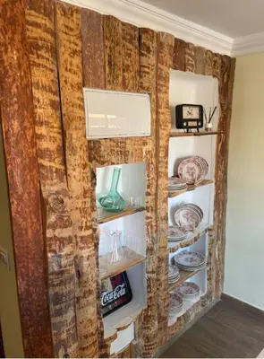 a corner of a room with a shelf with plates at Playa y cultura en el Cabanyal Alquiler de temporada familiar in Valencia
