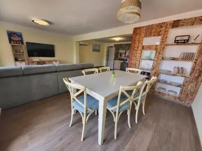 a dining room with a white table and chairs at Playa y cultura en el Cabanyal Alquiler de temporada familiar in Valencia