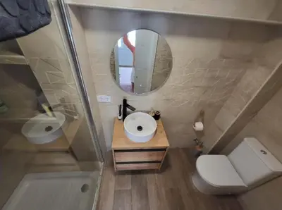 a small bathroom with a sink and a mirror at Playa y cultura en el Cabanyal Alquiler de temporada familiar in Valencia